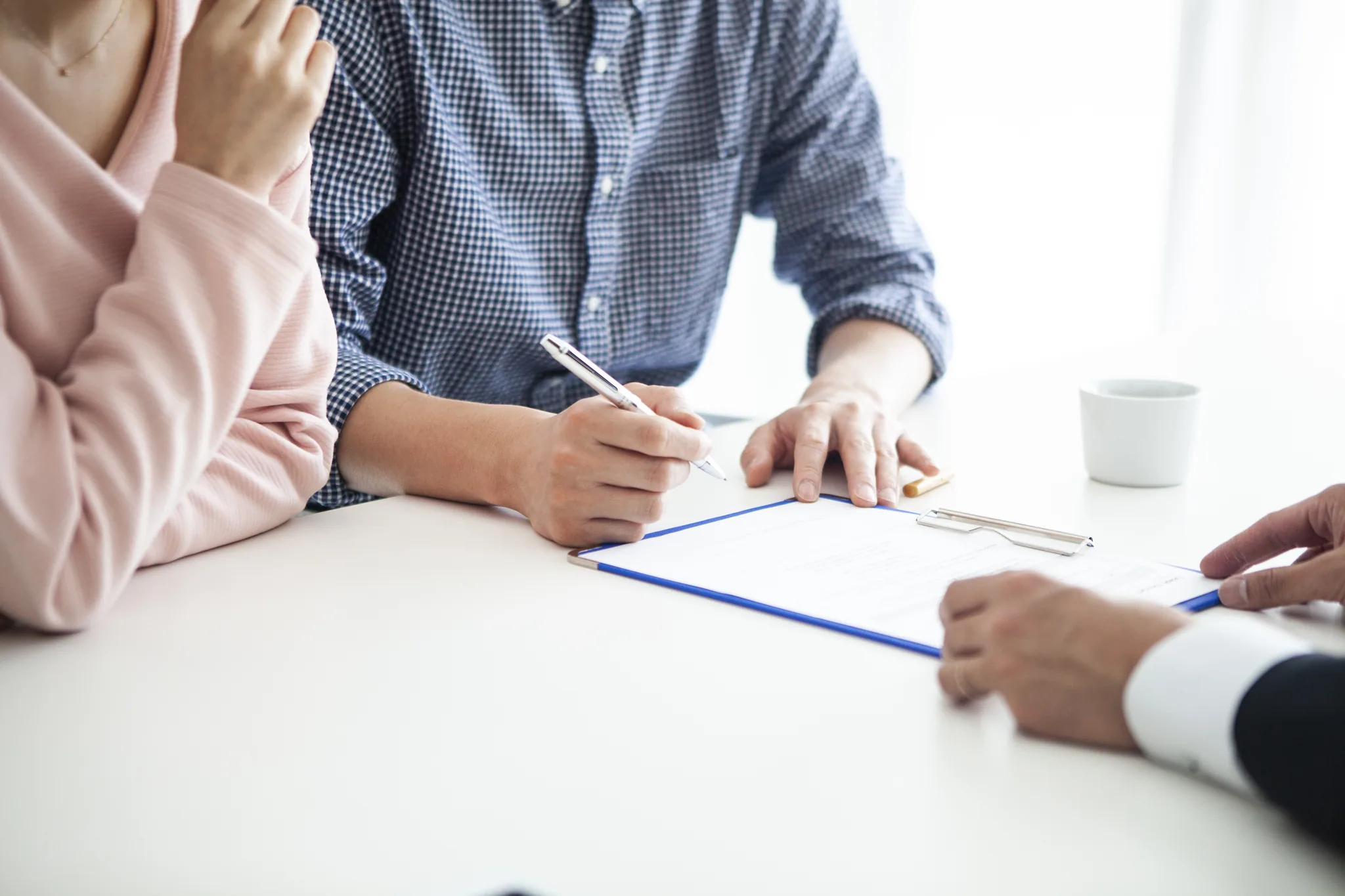 Fastighetsmäklare och kunder diskuterar villkor och strategi inför en bostadsaffär.