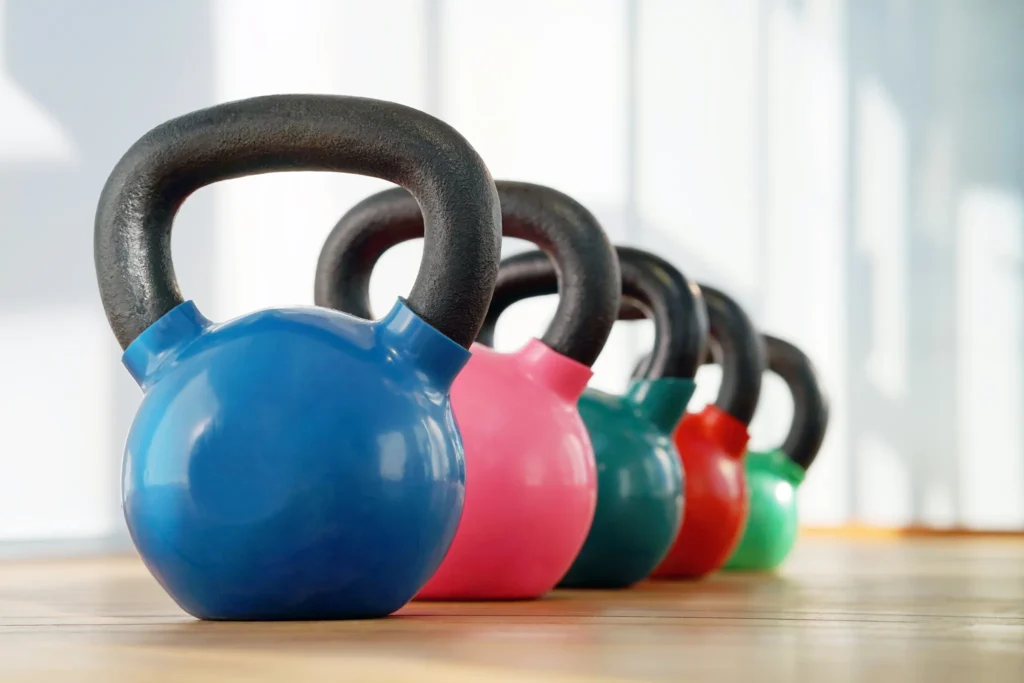 Färgade kettlebells i rad som symboliserar träning, utveckling och styrka – en bild av hur Yesbridge säljträning och workshop stärker säljares förmåga och prestation i kunddialoger.
